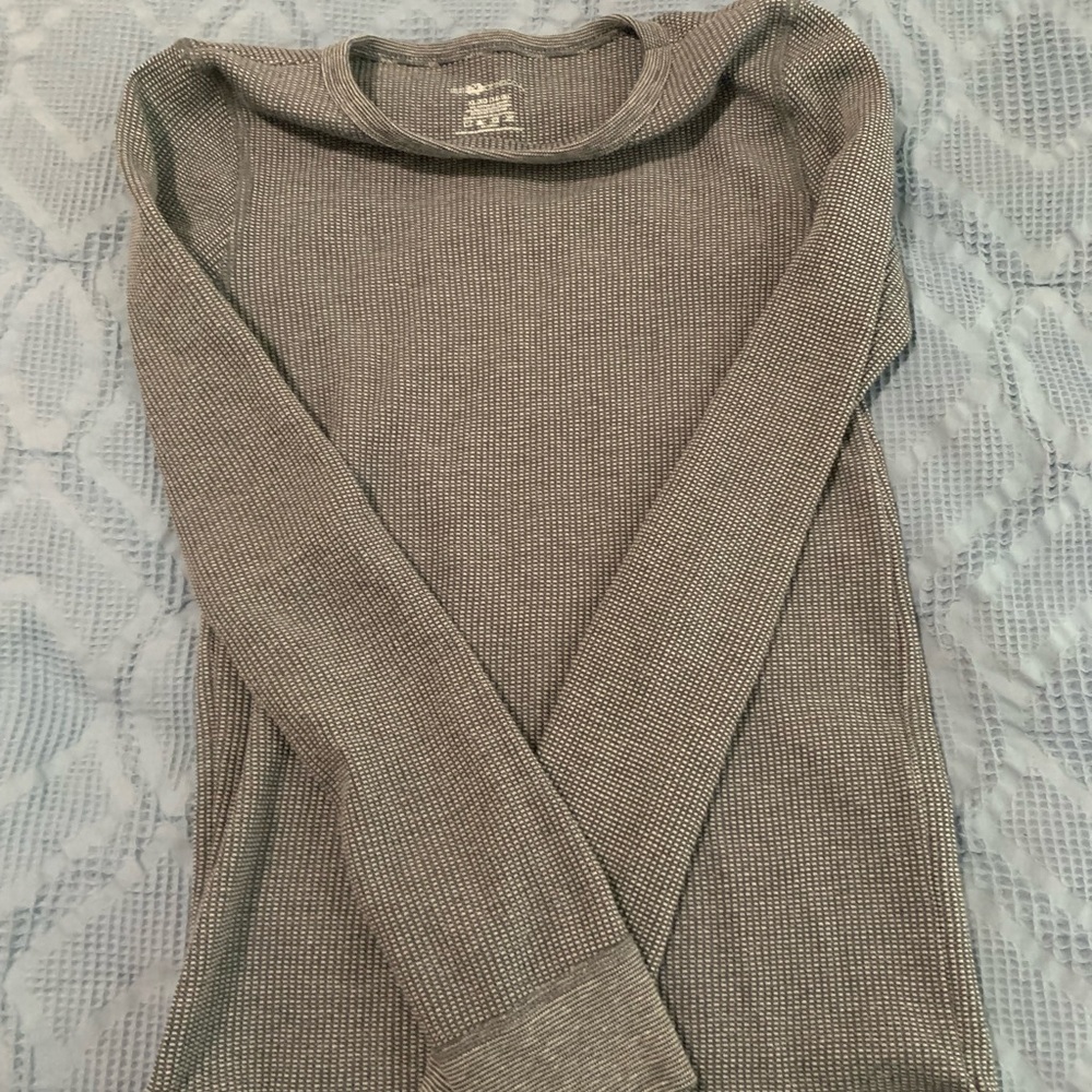 Two gray and black long sleeve boy’s shirts.